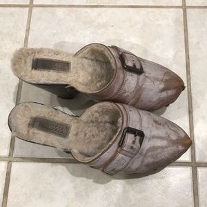 Brown and tan, fur lined clogs.